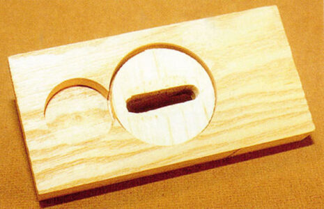 wooden board with a wooden key insert put in to a hole with a slightly smaller hole to the side cut part way through